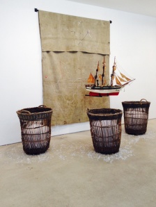 Radcliffe Bailey, To be Titled, 2012, tarp, iron, vintage model ship, wicker basket, and glass, 120 x 188 x 89 inches. Jack Shainman Gallery.