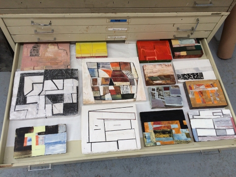 Small paintings stored in a flat file in Erik Neff’s studio.